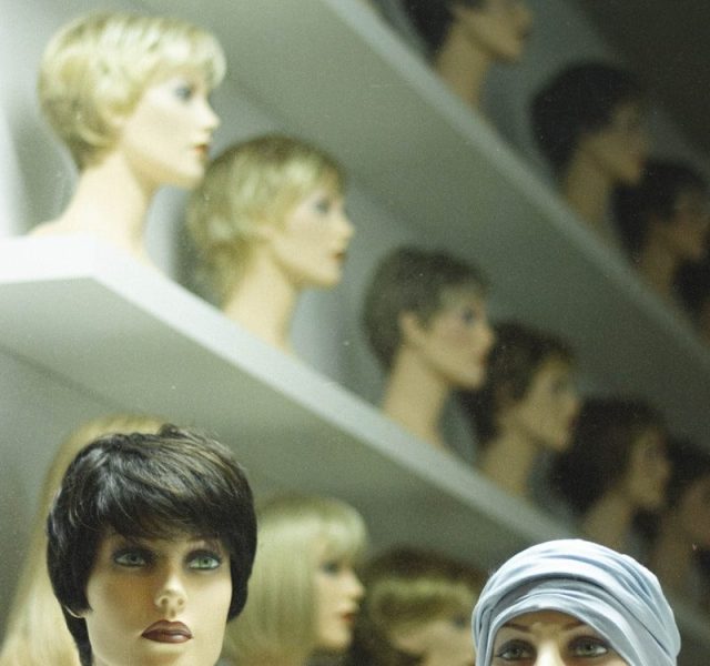 woman in white hijab beside woman in black shirt